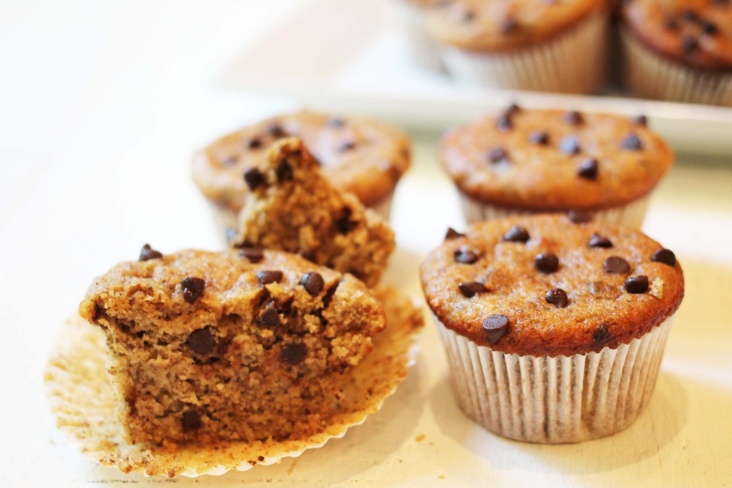 Cut open Maple Almond Butter Muffin with other muffins