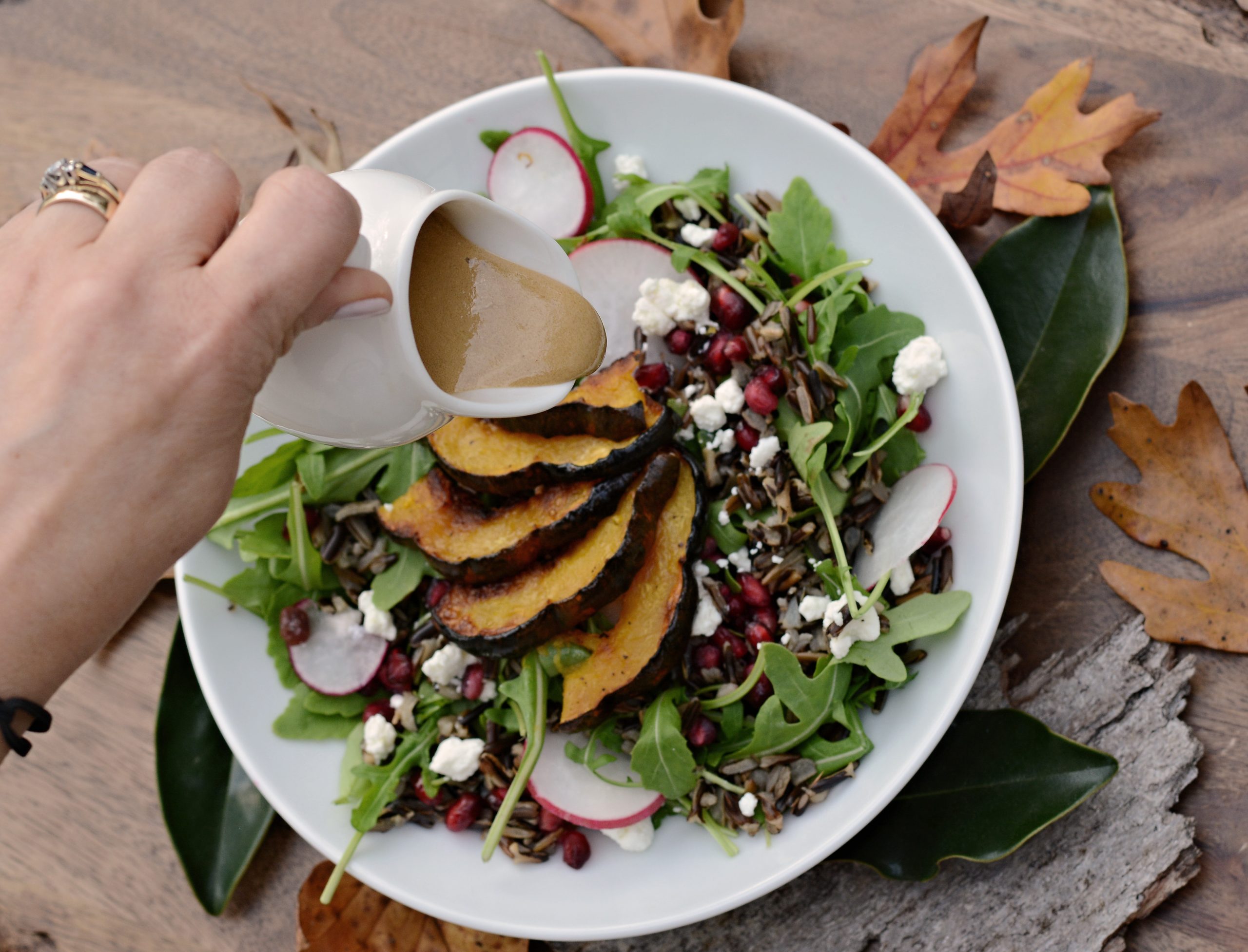 Acorn Squash Harvest Salad with balsamic being poured on top