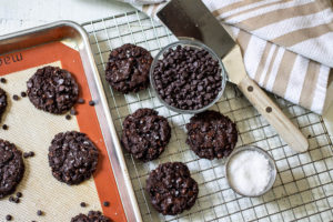 Vegan Double Chocolate Chip Cookies on cookie tray and cooling rack