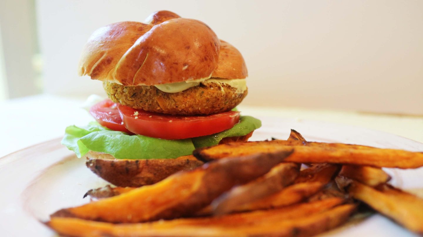 chickpea vegan burger on a plate with sweet potato fries