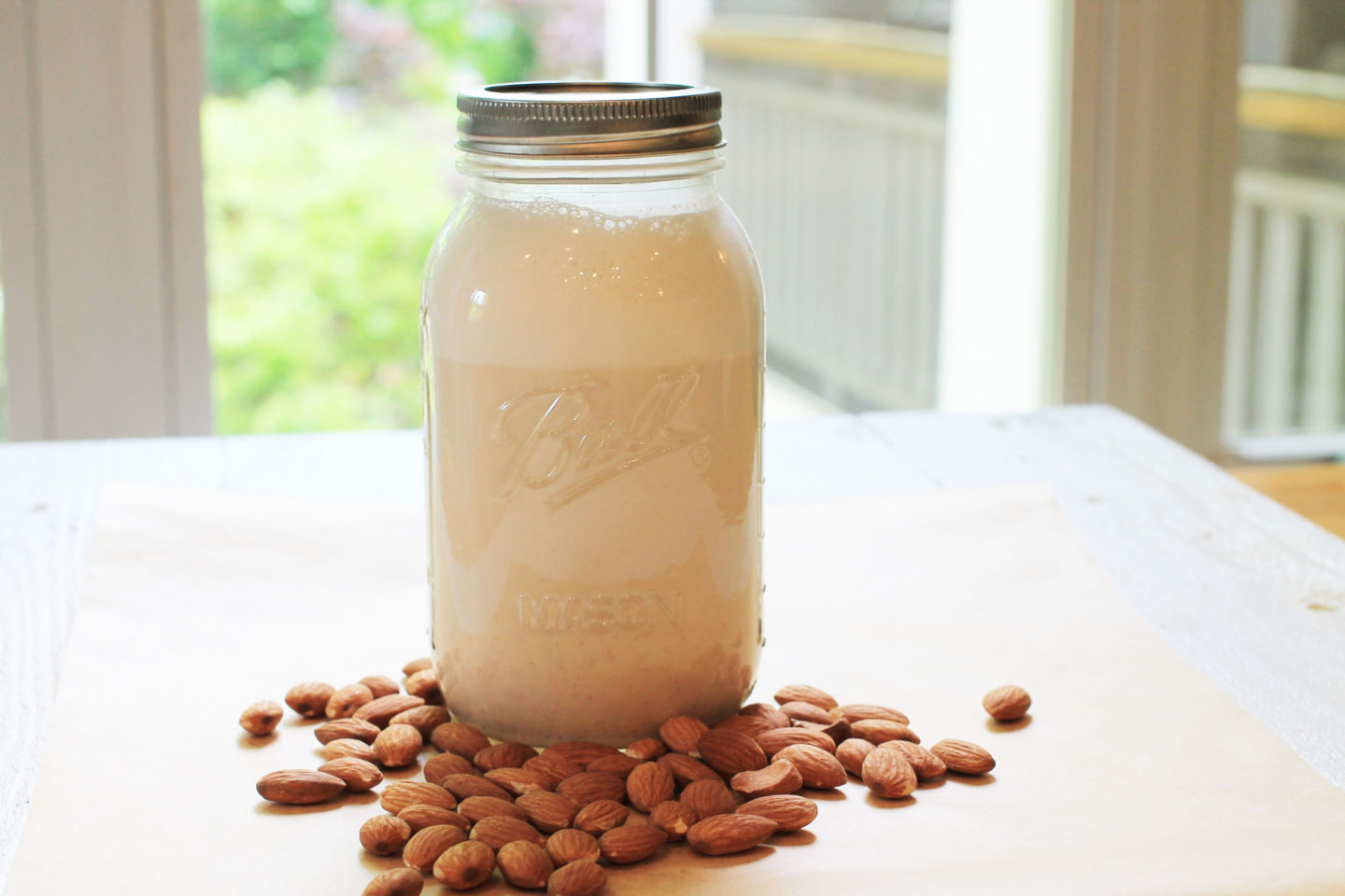 Homemade Almond Milk in Mason Jar with almonds