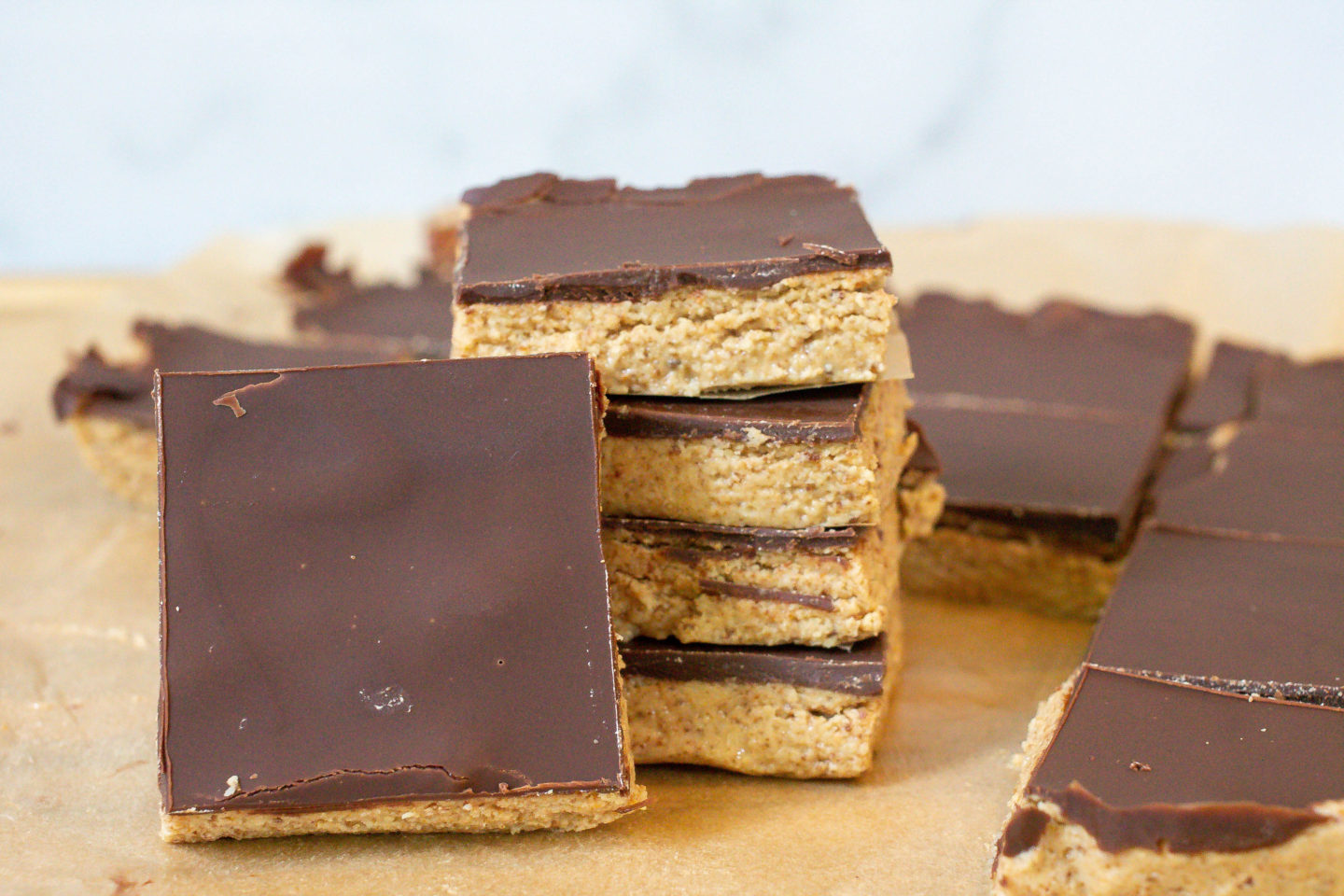Group of cut Homemade Protein Bars Stacked on Parchment paper