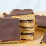 Group of cut Homemade Protein Bars Stacked on Parchment paper