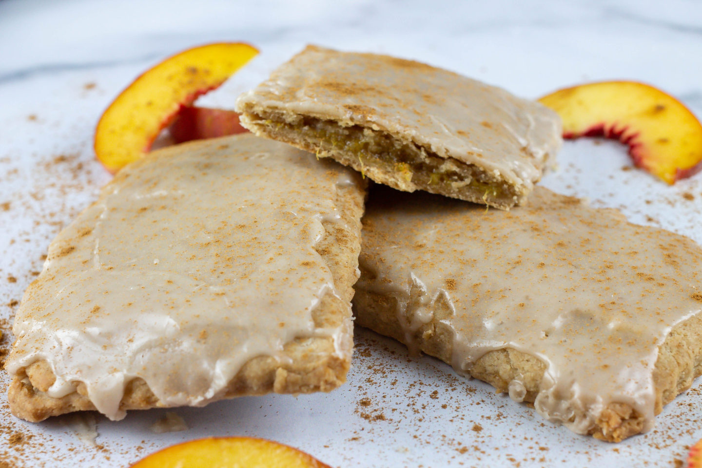 Homemade Pop-Tarts - Peach and Ginger Pop Tarts stacked on each other with fresh Peach slices