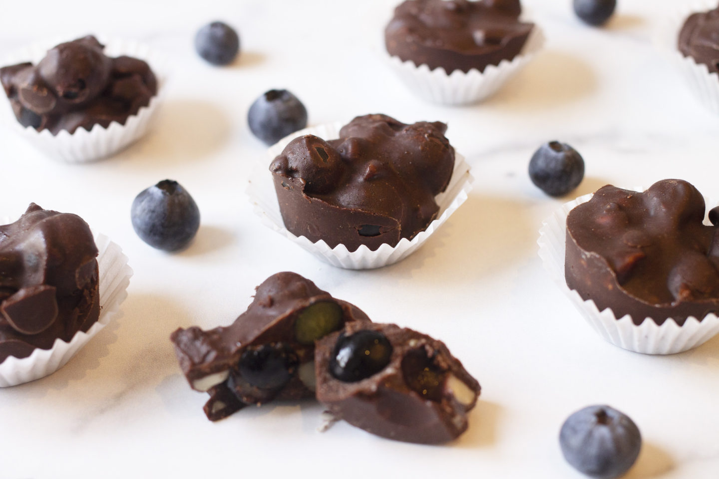 close up of halved chocolate with blueberries