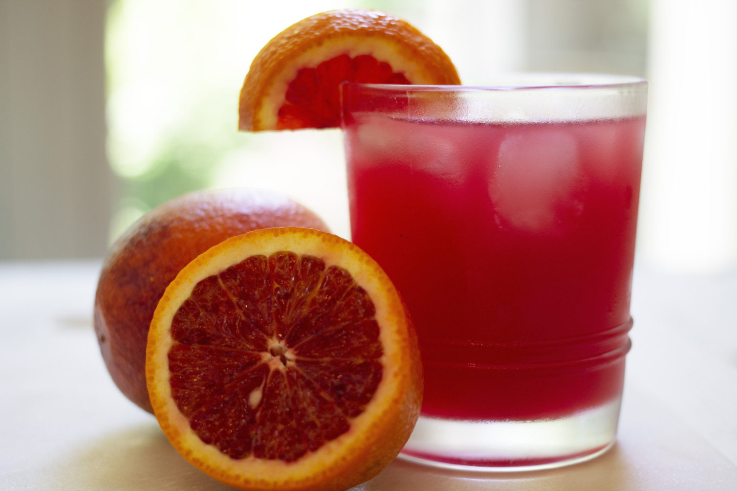 Close up of Blood Orange Skinny Margarita with Oranges