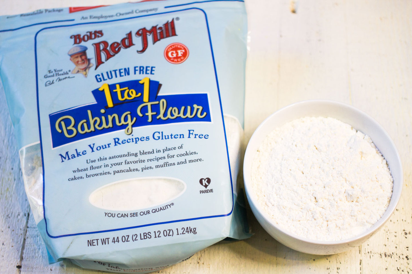 Bob's Red Mill 1 to 1 Gluten-Free Baking Flour with a small white bowl of flour