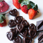 Chocolate shaped hearts filled with strawberry jam and a few fresh strawberries and chocolate chunks