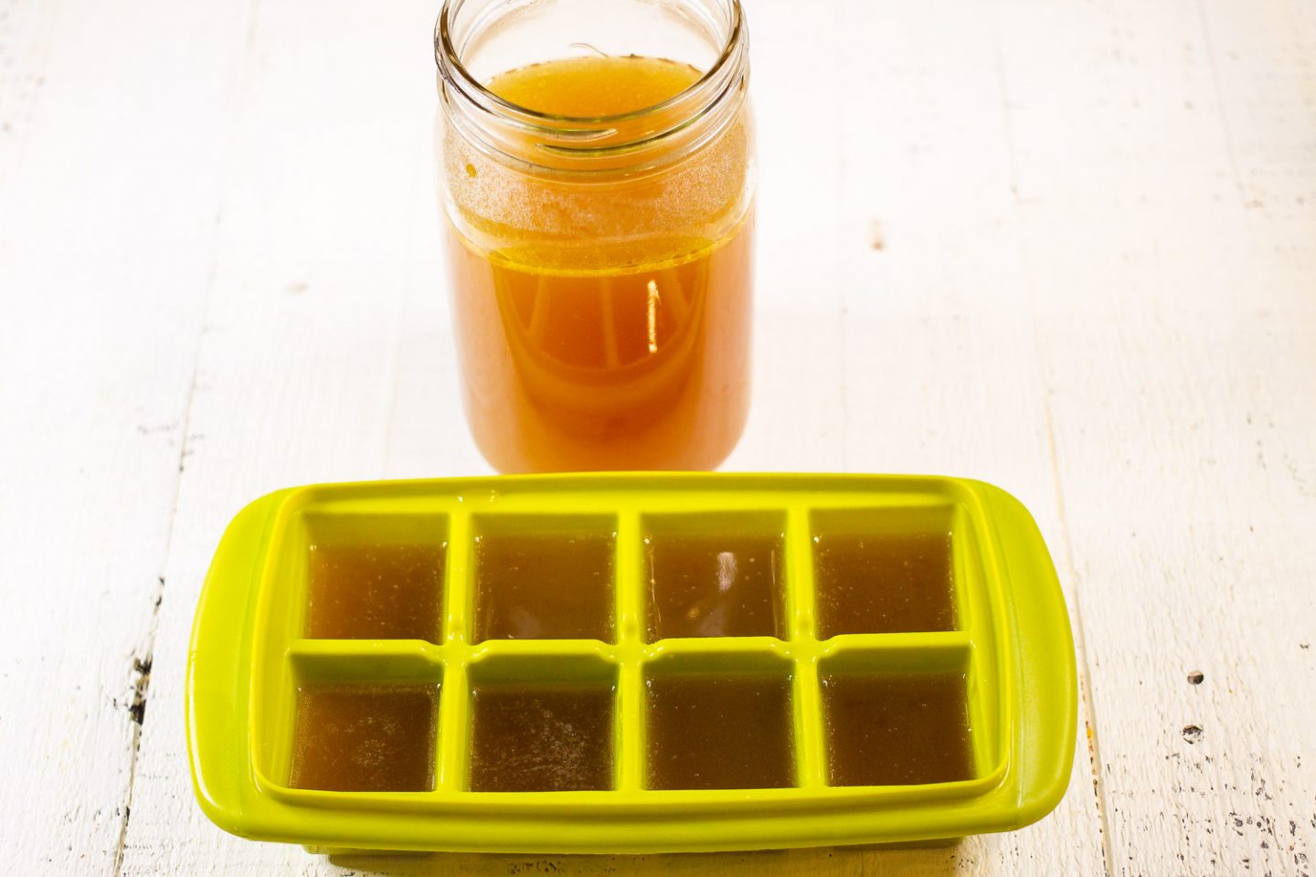 Chicken Bone Broth in a mason jar and in an ice cube tray